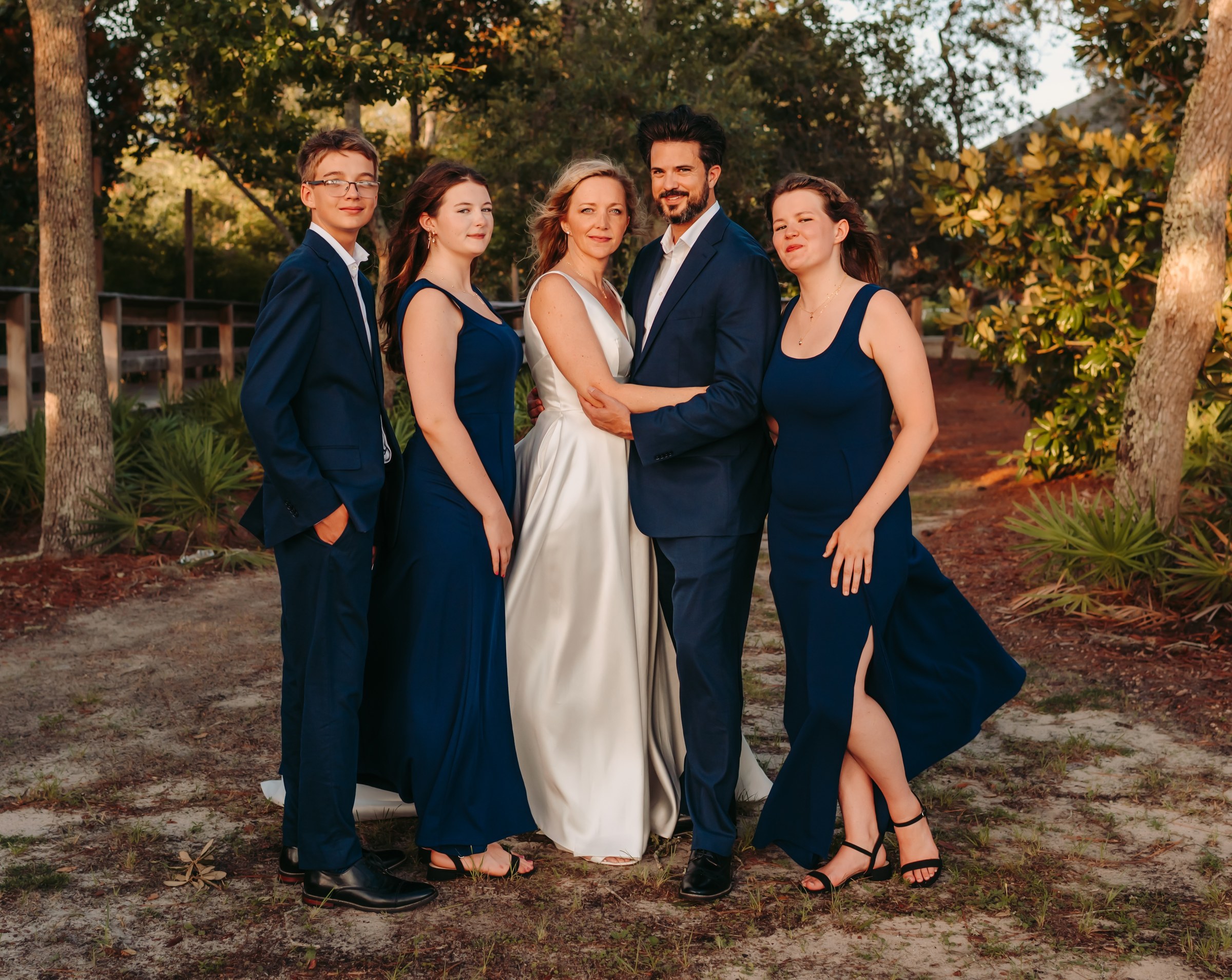 Cian Whalley with family in formal navy and white — grounded, family-business character